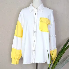 Off white denim jacket with colour patch pocket and arm sections and distinctive stitching