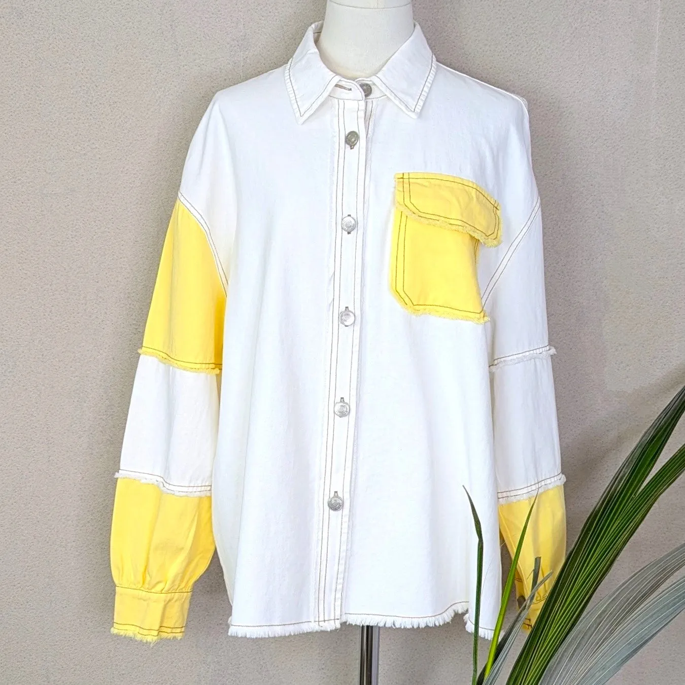 Off white denim jacket with colour patch pocket and arm sections and distinctive stitching